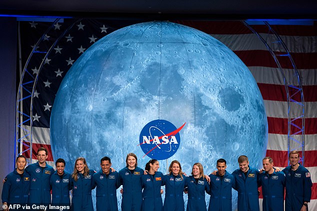 Astronauts from NASA and the Canadian Space Agency (CSA) acknowledge the audience during a graduation ceremony at the Johnson Space Center in Houston, Texas, in January 2020.