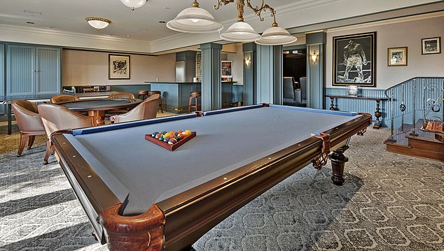 The lower level game room has a full bar with refrigerator, sink, stove and dishwasher.