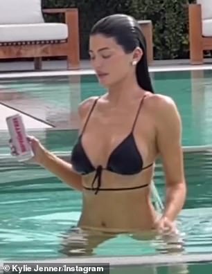 Kylie posed in a black string bikini to announce her new product on Tuesday.