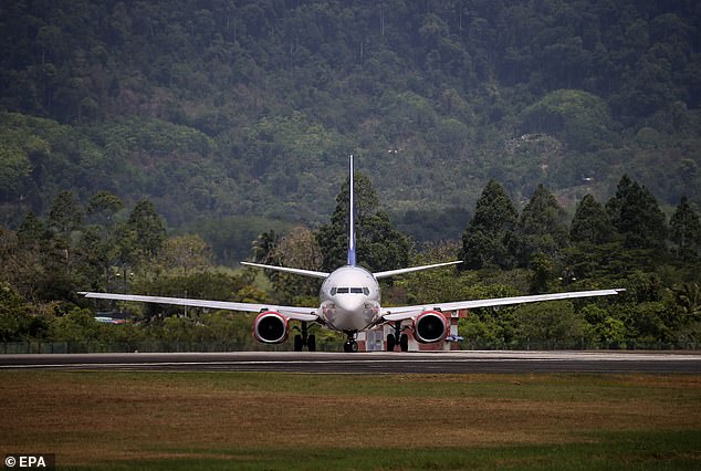 A Scandinavian Airlines (SAS) plane carrying King Harald V of Norway and delegates on the tarmac before taking off from Langkawi International Airport to return to Norway.