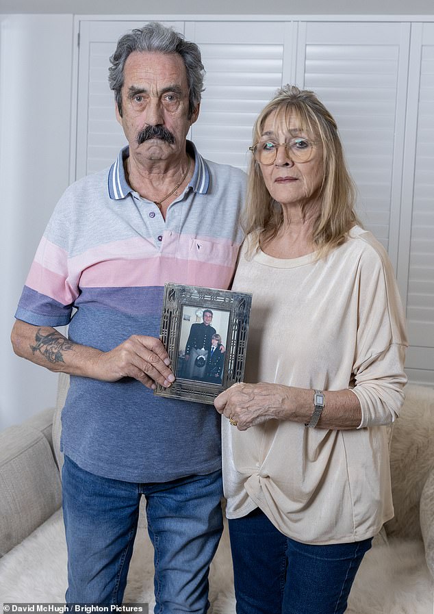Donald and Liz Shepherd from Sussex hold a photograph of their son Don, who was found dead in their van.