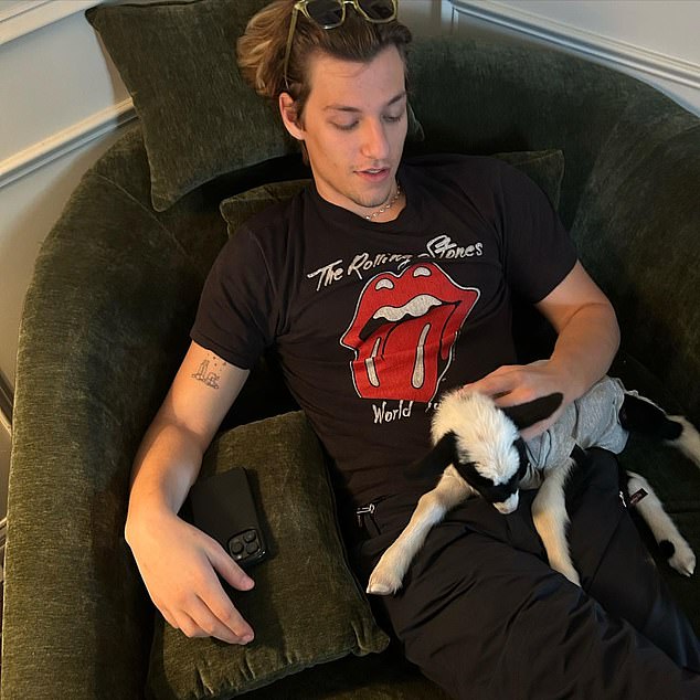 Millie admits the diapers were not for her unborn child, but for a lamb she was raising at home with her fiancé Jake Bongiovi, 21 (pictured with the lamb).