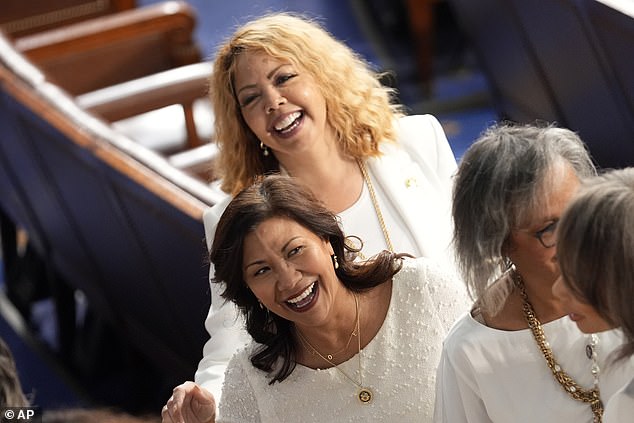 Reps. Norma Torres, D-Calif., back, and Rep. Lucy McBath, D-Ga., back, photographed in their white attire.