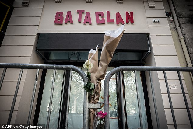 The flowers are tied to a fence outside the "Bataclan" concert hall during All Saints' Day in Paris on November 1, 2016, one of the targets of the terrorist attacks of November 13, 2015 during which 130 people were killed and another 413 injured in the French capital