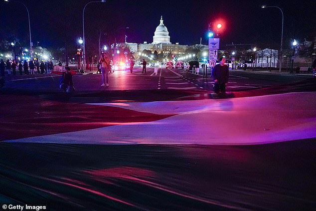 Protesters unfurled a huge Palestinian flag on Pennsylvania Avenue in Washington, D.C., in preparation to try to block the route Biden would normally take in his motorcade between the White House and the Capitol.
