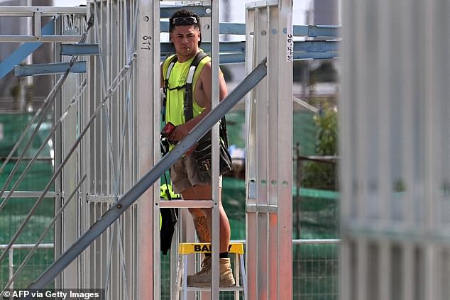 Due to a shortage of builders, very few women also work as tradesmen (pictured, a man working at an apartment construction site in Melbourne)