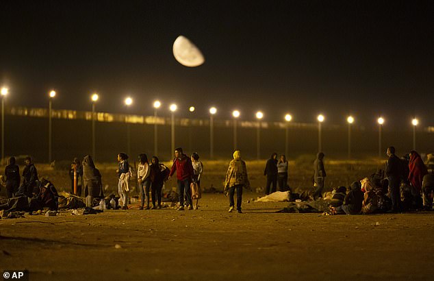 Migrants arrive at a gate in the border fence after crossing from Ciudad Juárez, Mexico, to El Paso, Texas, in the early hours of May 11.