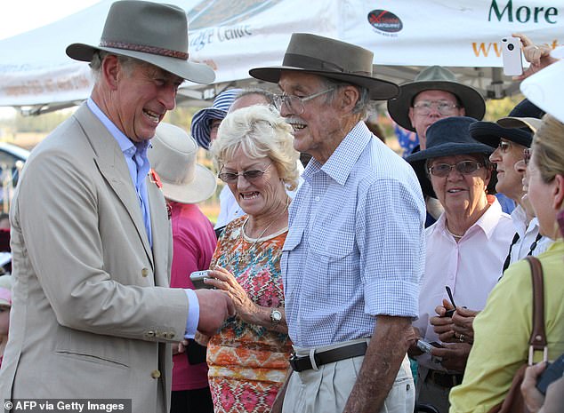 Prince Charles, wearing a fitting headdress, meets locals in the outback of Longreach, Queensland, in 2012.