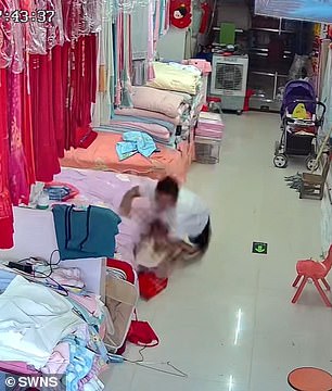 He lifted the baby with one arm before she fell to the ground.
