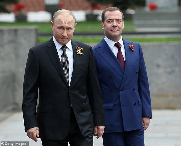 FILE: Russian President Vladimir Putin (L) and Prime Minister Dmitry Medvedev (R) in Moscow, May 9, 2019