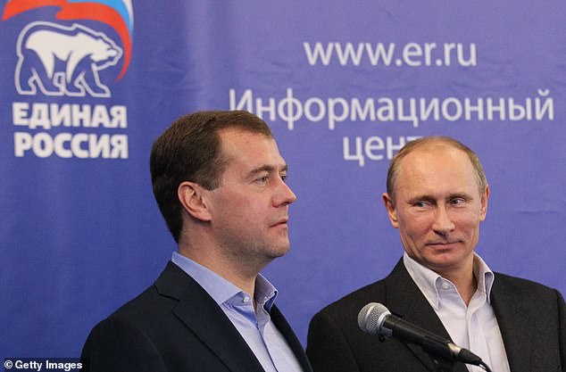 FILE: Russian Prime Minister Vladimir Putin (R) and President Dmitry Medvedev address members of the United Russia Party at the United Russia Party headquarters during the nationwide parliamentary elections December 4, 2011 in Moscow, Russia.