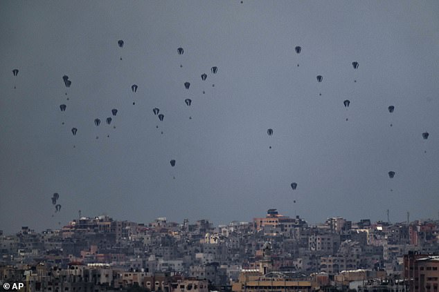 Parachutes drop supplies in the northern Gaza Strip, seen from southern Israel, Friday, March 8, 2024.