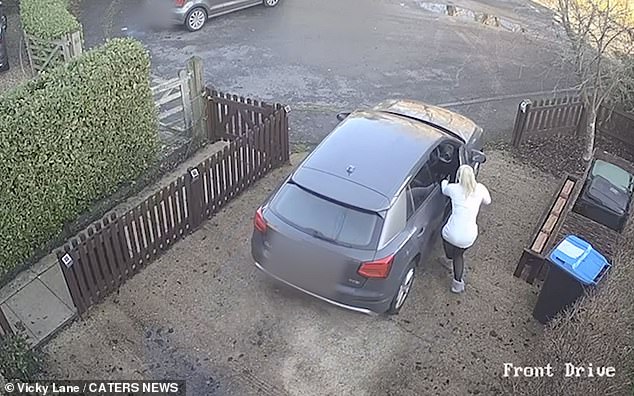 The 23-year-old makes a desperate attempt to get into the driver's seat of her car.