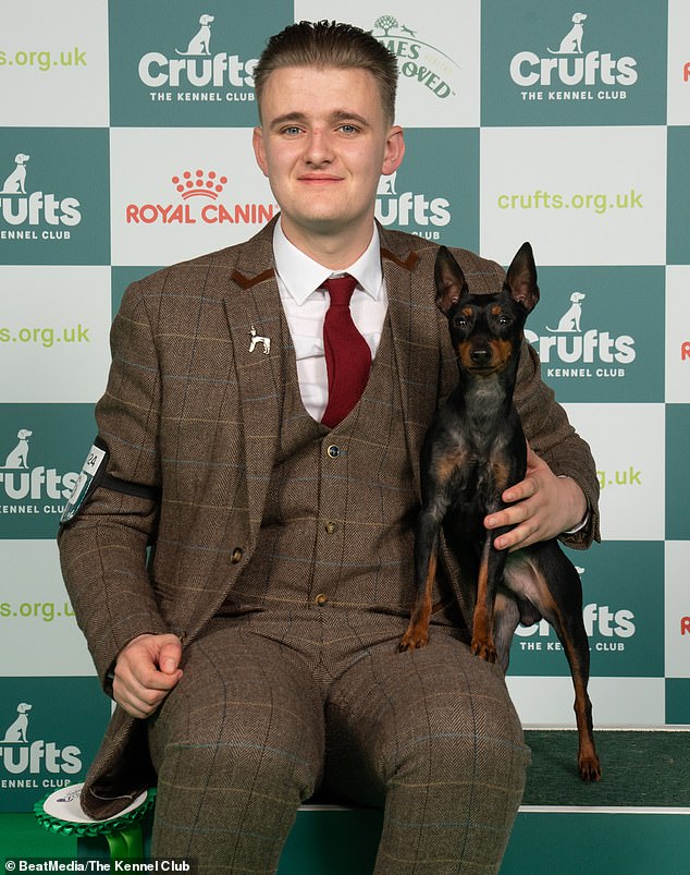 Jack Wood from East Sussex with Pike, an English Toy Terrier, Jack matched his black and tan suit to the color of his dog, which won best in breed award.