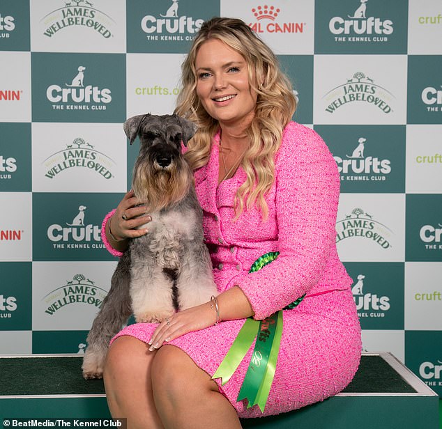 Beccie Woods of Tauton with Manny, a Miniature Schnauzer, who was the Best of Breed winner today. They both have long, straight, silky hair.