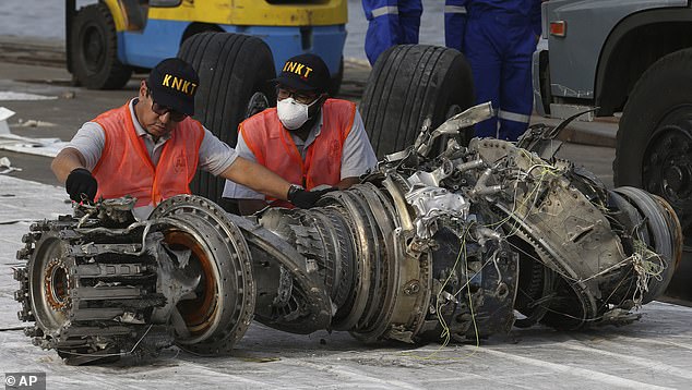The engine of a Lion Air Boeing 737 Max is inspected after it crashed in Indonesia in 2018
