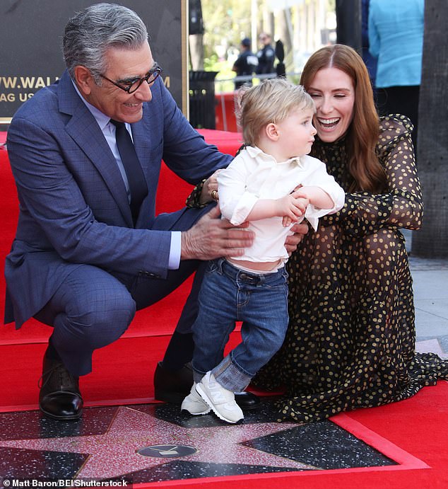 She brought her little one to the red carpet for stargazing, where she helped hold him up as he wobbled across his grandfather's name.