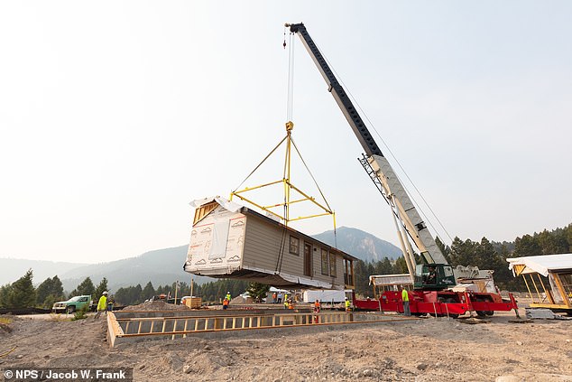 One of the new modular homes is seen being placed into position.