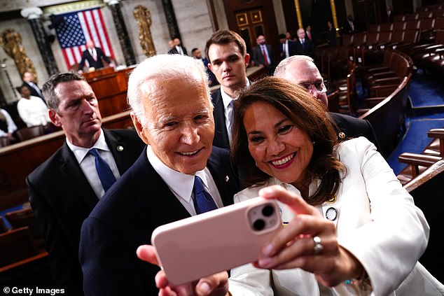 The president poses for a selfie after his last speech before the November elections