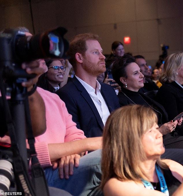 Prince Harry is seen in the audience supporting his wife Meghan as she speaks on the panel.