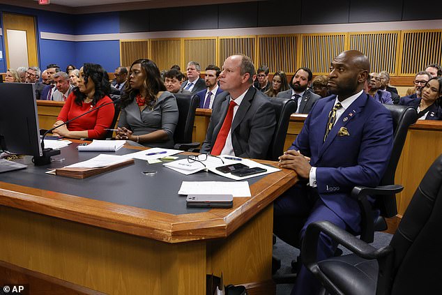 Willis (left) and her ex-boyfriend Wade (right) sit at the prosecutor's table during closing arguments at her disqualification hearing on March 1.