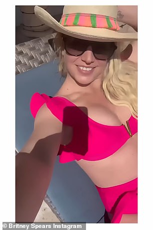 Spears flaunted her toned figure in a hot pink bikini top and matching high-waisted pants.