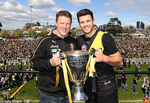 Hardwick, pictured with Trent Cotchin and the AFL premiership trophy, turned the Tigers around during his time as coach.