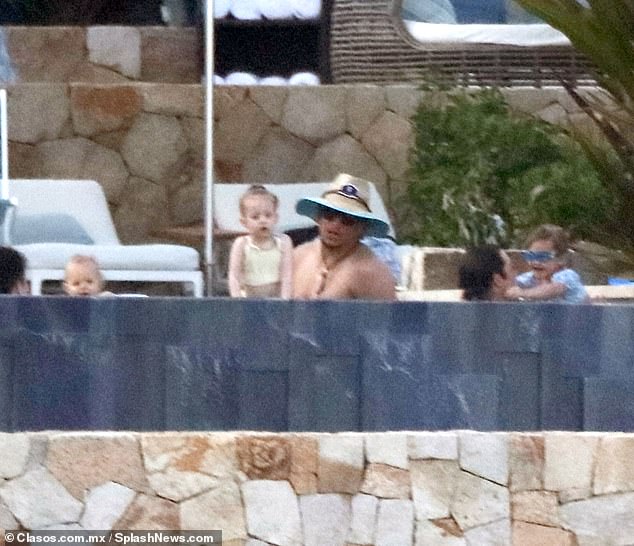 He appeared to watch the cameras as he and his daughter Sterling hung out in the water.
