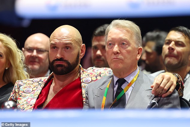 Tyson Fury (left) watched him at ringside and his reaction to the knockout has gone viral