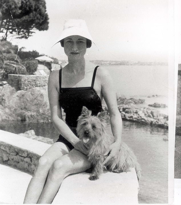 Wallis on holiday in the south of France in 1935 with her beloved dog and her slipper.