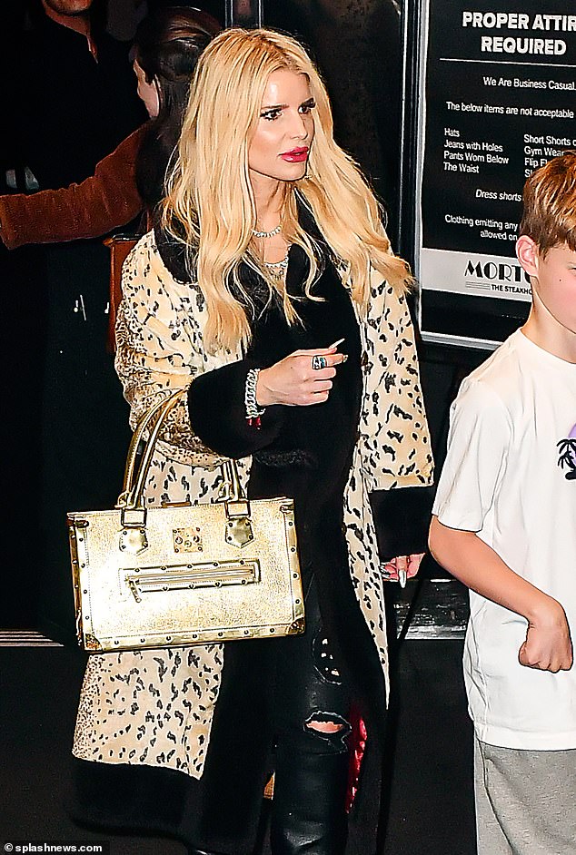 The fashionista carried a large gold bag as she enjoyed quality time with her family members.