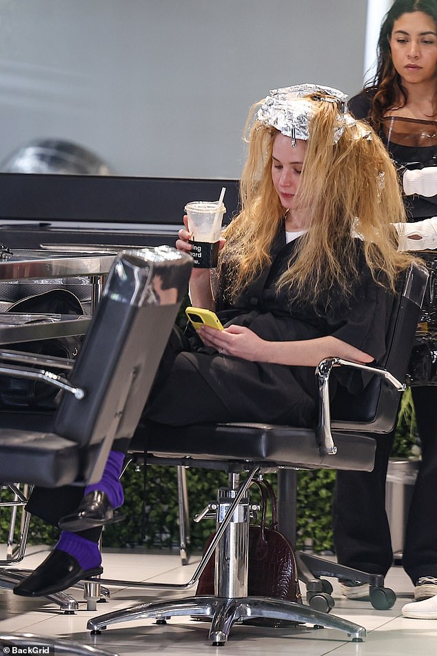 Foils lined the top of her head as her stylist worked to highlight the mother's long blonde hair.