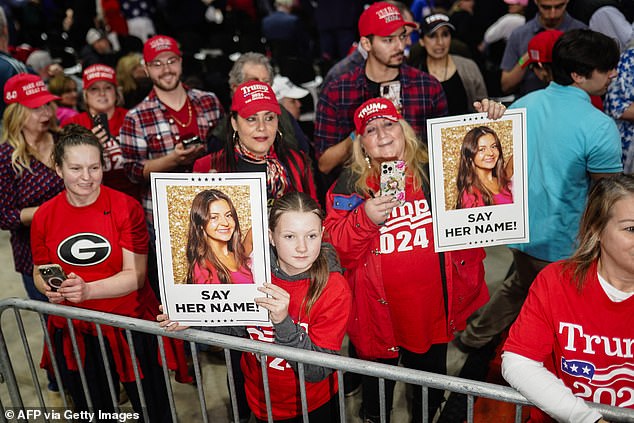 Attendees at Trump's rally at the Forum River Center in Rome, Georgia, Saturday, March 9, 2024, hold signs with images of Laken Riley, 22. An illegal immigrant was charged with her murder.
