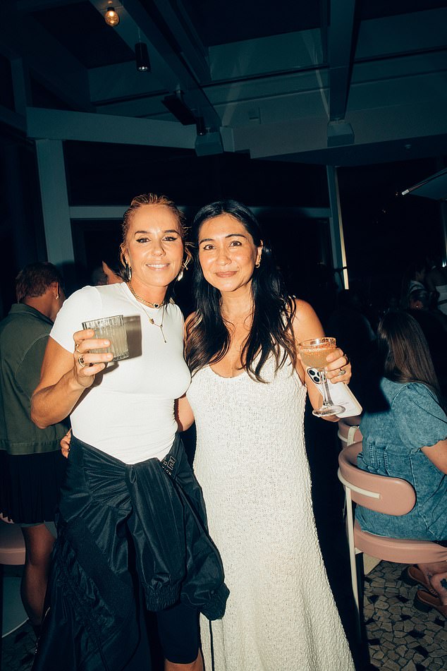 Former Elle Australia magazine editor Justine Cullen (right) was photographed at the party alongside Edwards (left) in a simple white sleeveless dress.