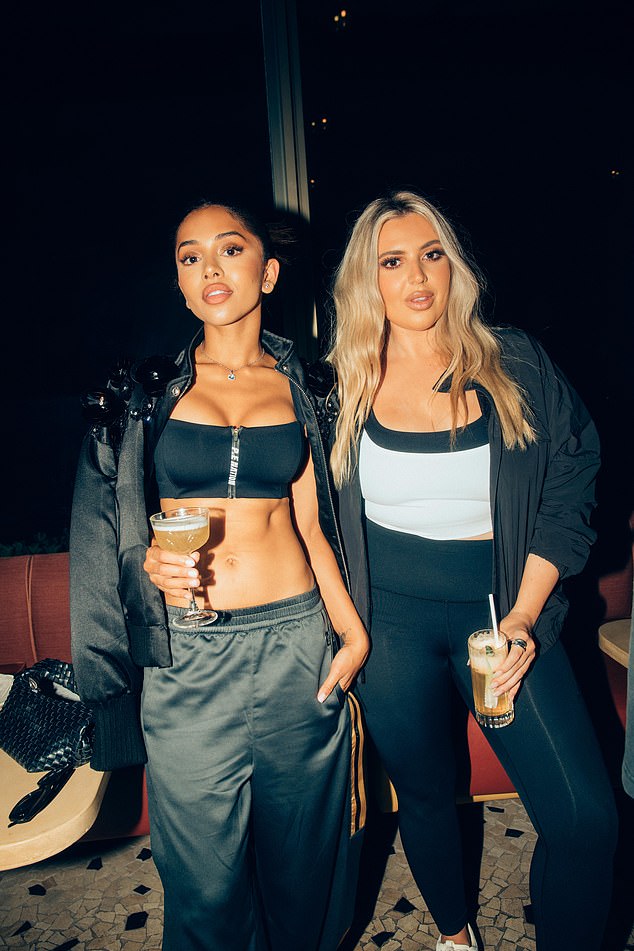Maria Thattil (left) was also in attendance and opted for a sporty-chic look including a black bandeau top and a pair of dark green pants with a gold stripe (pictured with Shannan Sophia).