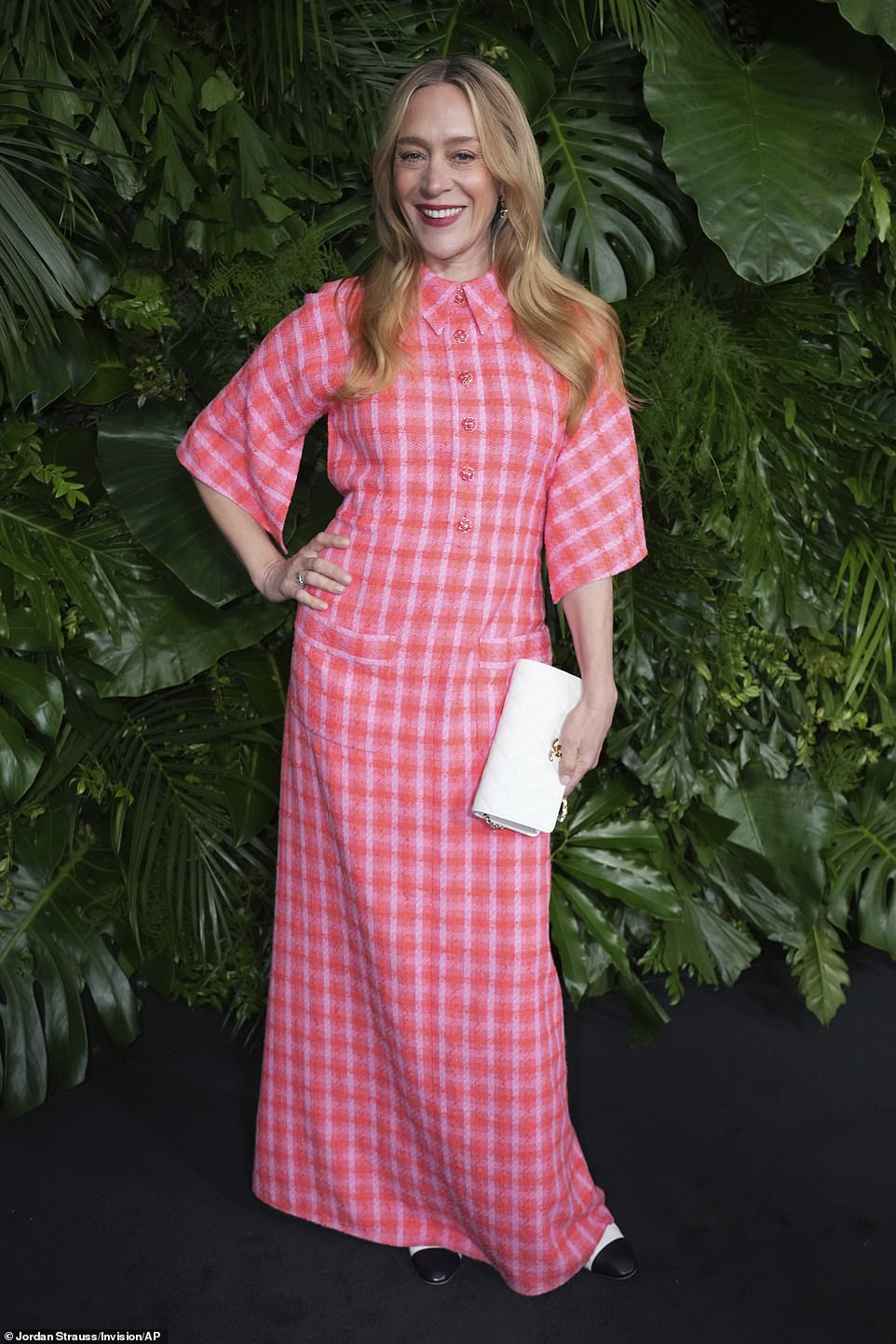Chloe Sevigny looked radiant in a pink and orange plaid dress that had two pockets around the lower waist and buttons at the top.