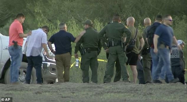 Authorities are seen at the scene of Friday afternoon's helicopter crash in Texas.