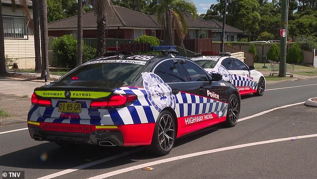 Police cars from the New South Wales Highway Patrol are photographed at the scene on Rawson Road, Guildford.