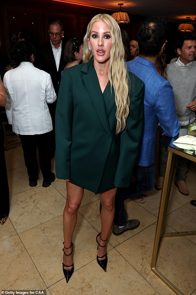 The singer, 37, was a vision of beauty in an emerald green blazer dress that showed off her tan and toned pins