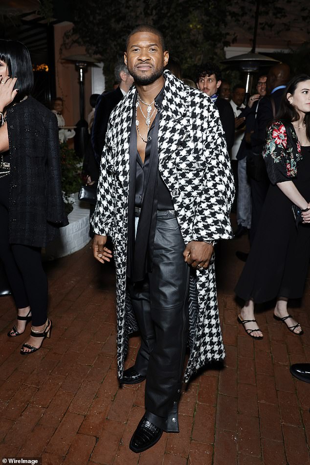 Usher donned a black and white coat as he partied with A-list celebrities