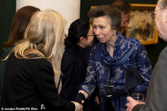 The Princess Royal opted for simple black heels and styled her hair in a signature style.  She was wearing black gloves and holding an indigo clutch.  Adding a flash of color, the late Queen Elizabeth's only daughter applied bright lipstick.