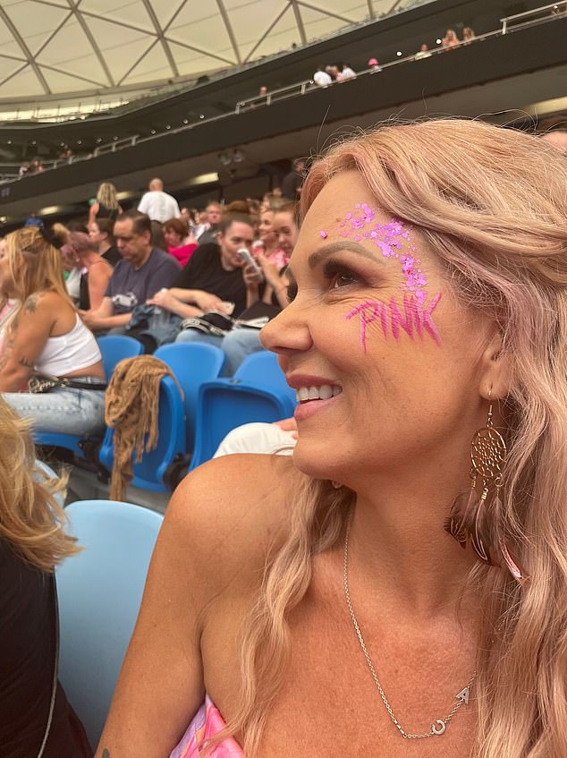 The mother-of-two was glowing with her face adorned with glittery pink makeup and the iconic pop star's name artistically painted on her cheek