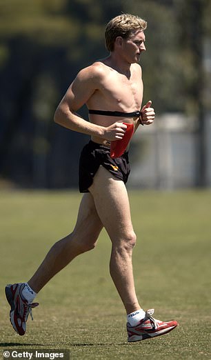 Hird runs without his jersey during his playing days
