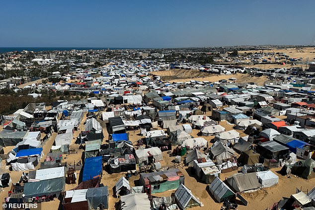 Displaced Palestinians shelter in a tent camp amid the ongoing conflict between Israel and the Palestinian Islamist terrorist group Hamas in Rafah in the southern Gaza Strip