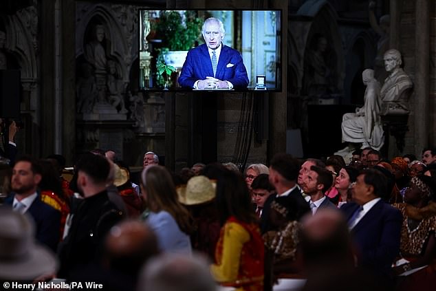 Guests watch a video of King Charles III delivering a message during the annual Commonwealth Day Service