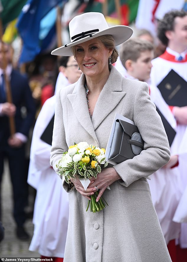Sophie smiled as she held a bouquet of flowers given to her by school children outside the event.