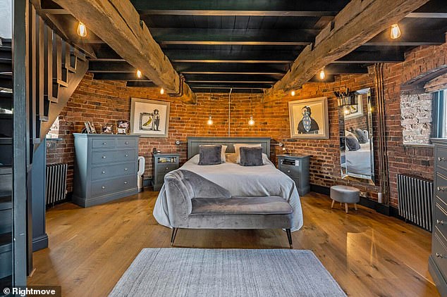 All four bedrooms including this large room with wooden floors and beamed ceilings.