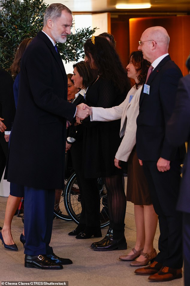 King Felipe VI looked equally elegant in a navy blue suit and tie which he paired with a white striped shirt.