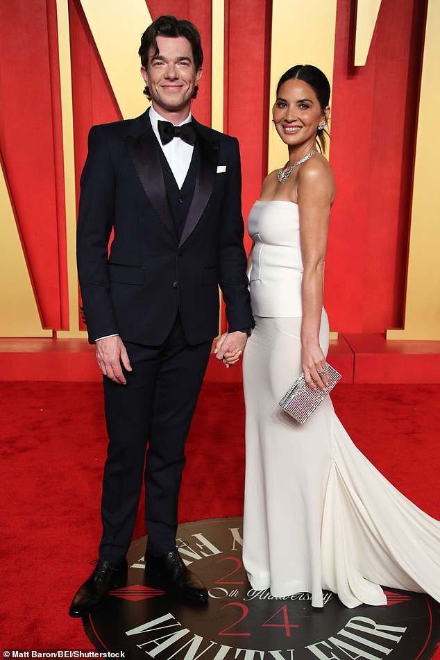 Pictured: John Mulaney and Olivia Munn hold hands as they walk the red carpet at the Vanity Fair Oscars after-party.