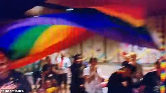 The video shows him making children pledge allegiance to LGBTQ pride flags